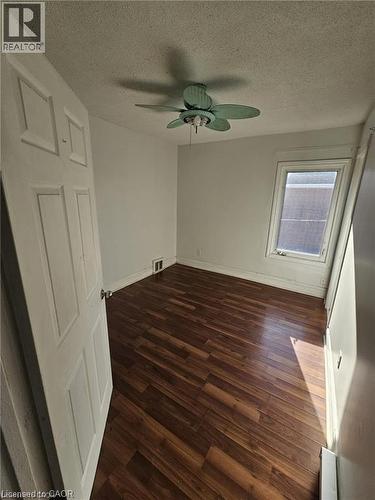 The room features a ceiling fan, a window, and wood-look flooring - 219 Avondale Street, Hamilton, ON - Indoor Photo Showing Other Room