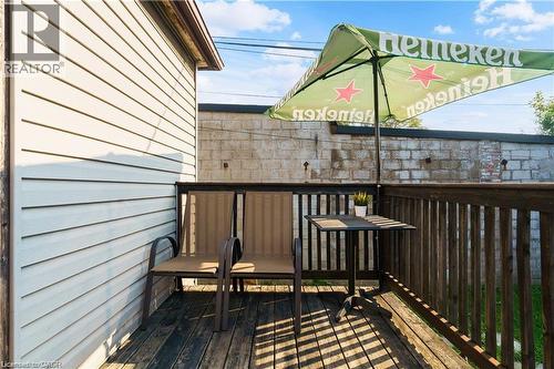 Property features a wooden deck with railing, ideal for outdoor relaxation - 219 Avondale Street, Hamilton, ON - Outdoor With Exterior