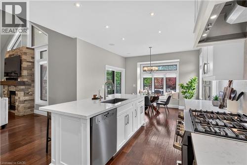 Modern kitchen island featuring a deep undermount sink, stainless steel dishwasher, and a light-toned countertop - 2050 15 Side Road, Milton, ON - Indoor Photo Showing Kitchen With Upgraded Kitchen