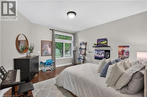 Bedroom featuring a vaulted ceiling and dark wood-finish flooring - 2050 15 Side Road, Milton, ON - Indoor Photo Showing Bedroom