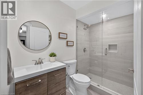Bathroom with a frameless glass shower enclosure featuring large-format rectangular wall tiles and a hexagonal floor tile - 2050 15 Side Road, Milton, ON - Indoor Photo Showing Bathroom
