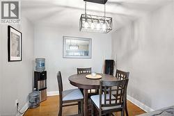 Light gray walls with white trim and wood-finish flooring - 