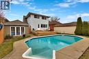 Rear exterior featuring an in-ground swimming pool, concrete pool deck, and a multi-level wood deck - 371 Ottawa Street S, Kitchener, ON  - Outdoor With In Ground Pool 