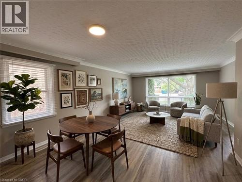Spacious living area featuring wood-finish flooring, crown molding, and large windows - 20 Lloyd Manor Road, Etobicoke, ON - Indoor Photo Showing Living Room