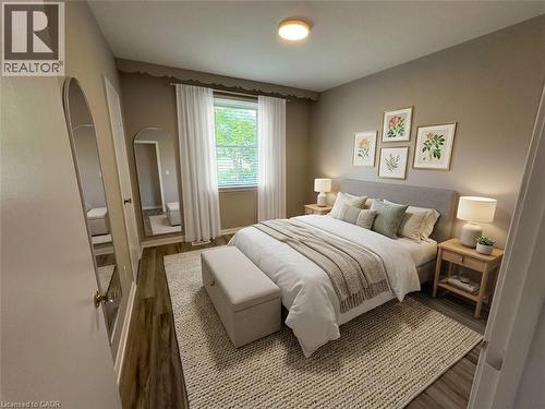Bedroom featuring wood-finish flooring, a window with blinds, and a built-in overhead light fixture - 20 Lloyd Manor Road, Etobicoke, ON - Indoor Photo Showing Bedroom
