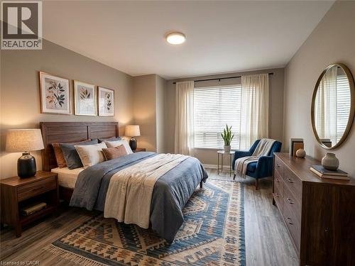 Spacious room featuring wood-finish flooring, a large window with blinds and sheer curtains, and warm neutral wall tones - 20 Lloyd Manor Road, Etobicoke, ON - Indoor Photo Showing Bedroom