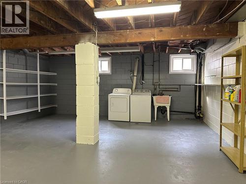 Spacious utility area featuring exposed ceiling joists, painted concrete block walls, and a durable gray concrete floor - 20 Lloyd Manor Road, Etobicoke, ON - Indoor Photo Showing Basement