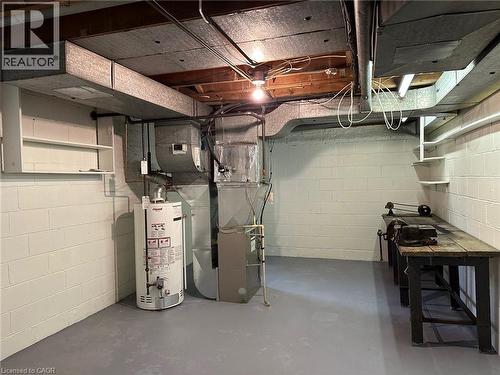 Utility area featuring painted concrete block walls and a gray painted floor - 20 Lloyd Manor Road, Etobicoke, ON - Indoor Photo Showing Basement