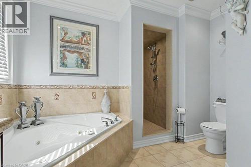 Corner jetted soaking tub with a tiled surround - 284 Normanhurst Avenue, Hamilton, ON - Indoor Photo Showing Bathroom