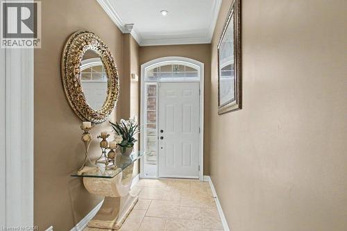 Entryway featuring a white paneled door with an arched transom, sidelight windows, and tile flooring - 284 Normanhurst Avenue, Hamilton, ON - Indoor Photo Showing Other Room