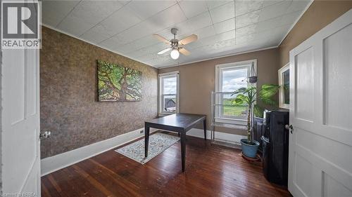 Room featuring wood-finish flooring, two windows with trim, and a ceiling fan with integrated lighting - 3211 Highway 3, Jarvis, ON - Indoor Photo Showing Other Room