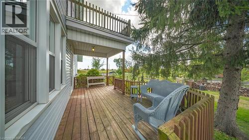 Expansive wood-finish deck with a wood railing and mature evergreen trees - 3211 Highway 3, Jarvis, ON - Outdoor With Deck Patio Veranda With Exterior
