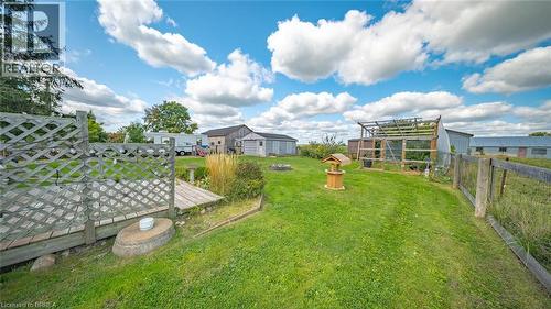Expansive grassy area featuring multiple outbuildings, wood lattice fencing, and a wooden bridge structure - 3211 Highway 3, Jarvis, ON - Outdoor With View