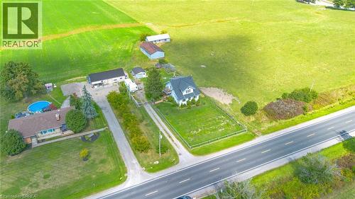 Expansive property featuring a white residence with a dark roof, surrounded by green fields - 3211 Highway 3, Jarvis, ON - Outdoor With View