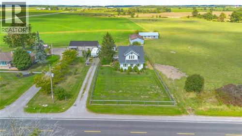 Charming white siding residence featuring a dark roof and a prominent dormer window - 3211 Highway 3, Jarvis, ON - Outdoor With View