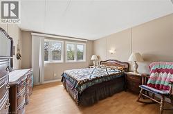 Light wood-finish flooring complements the neutral wall paneling - 