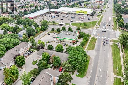 Aerial perspective showcasing a retail plaza featuring a grocery store and additional commercial spaces - 7332 Twenty Road E, Glanbrook, ON - Outdoor With View