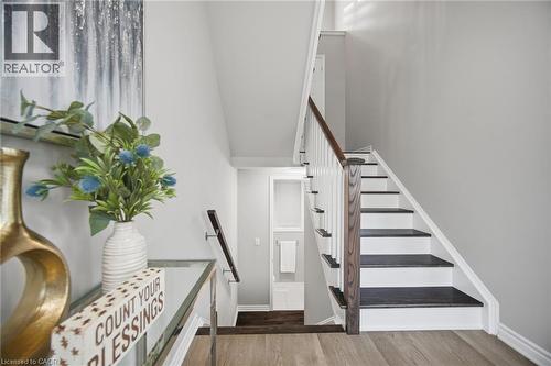 Staircase featuring dark wood-finish treads, white risers, and white balusters with a dark wood-finish handrail - 542 Boyd Lane, Milton, ON - Indoor Photo Showing Other Room