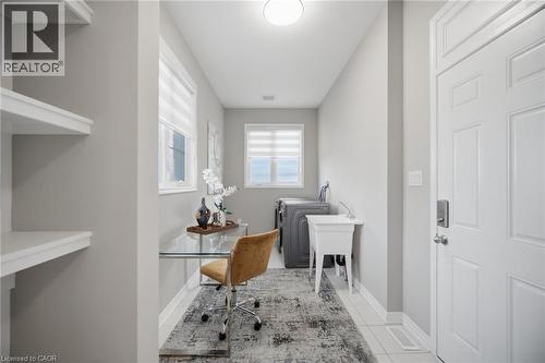 Dedicated laundry area featuring a utility sink, washer and dryer connections, and a built-in shelf system - 542 Boyd Lane, Milton, ON - Indoor