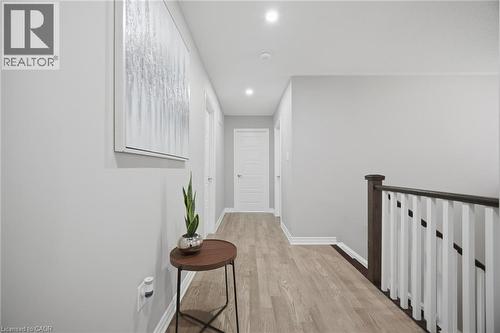 Hallway featuring light-toned wood-finish flooring, recessed lighting, white baseboards, and interior doors - 542 Boyd Lane, Milton, ON - Indoor Photo Showing Other Room