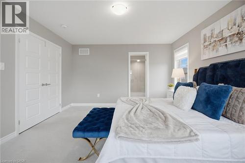 Carpeted bedroom featuring neutral wall tones, white trim, and a window with natural light - 542 Boyd Lane, Milton, ON - Indoor Photo Showing Bedroom