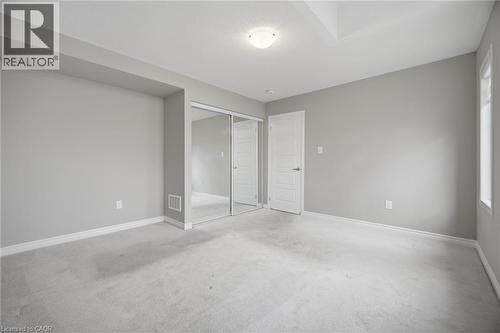 Carpeted room with light gray walls, white baseboards, and a white ceiling - 542 Boyd Lane, Milton, ON - Indoor Photo Showing Other Room