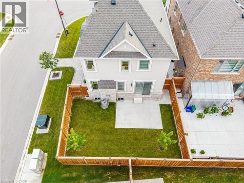 Rear facade featuring a stone-clad first level and stucco upper levels - 542 Boyd Lane, Milton, ON - Outdoor