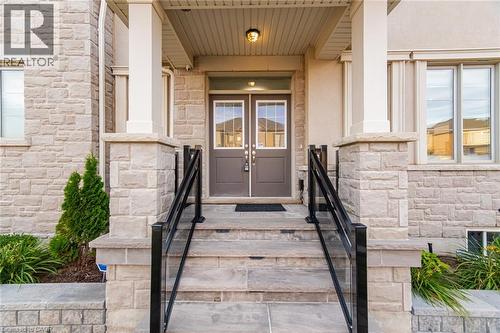 Stone facade with dual entry doors featuring upper glass panels - 542 Boyd Lane, Milton, ON - Outdoor