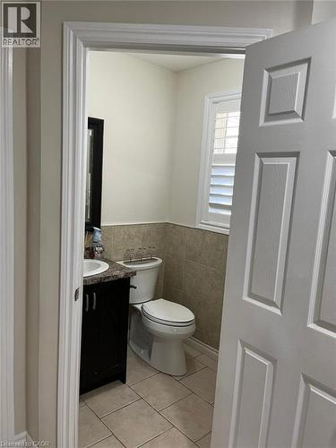 Bathroom featuring a dark wood-finish vanity with a white basin sink and an attached mirror - 1367 Upper Paradise Road, Hamilton, ON - Indoor Photo Showing Bathroom