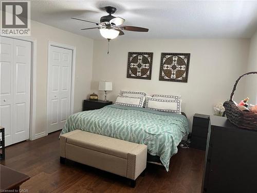 Bedroom featuring wood-finish flooring, two sets of bi-fold closet doors, a ceiling fan with integrated lighting, and neutral wall tones - 1367 Upper Paradise Road, Hamilton, ON - Indoor Photo Showing Bedroom