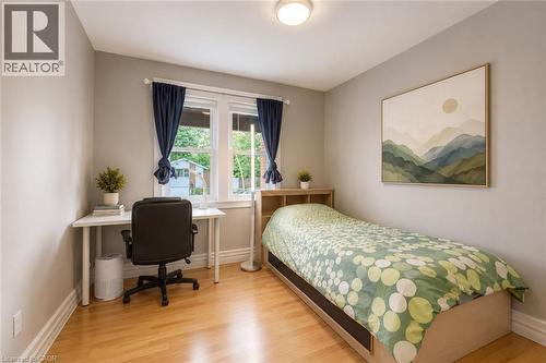 Bright room featuring light wood-finish flooring, neutral painted walls, and white trim - 74 Royal Avenue, Hamilton, ON - Indoor Photo Showing Bedroom