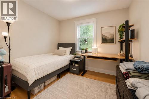 Light-filled room featuring wood-finish flooring, a window with blinds, and neutral wall tones - 74 Royal Avenue, Hamilton, ON - Indoor Photo Showing Bedroom
