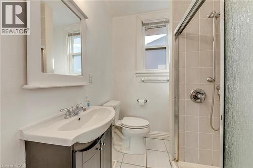 Bathroom featuring a vanity with an integrated sink, chrome faucet, and storage cabinetry - 74 Royal Avenue, Hamilton, ON - Indoor Photo Showing Bathroom