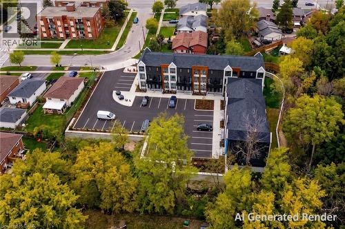 Modern multi-story residential building with a dark facade and light accents, featuring a large asphalt parking area with designated spaces - 210 Heritage Drive Unit# Main, Kitchener, ON - Outdoor With View