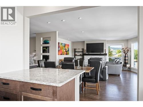 View from Kitchen through Dinnign Room to Living Room - 4119 15 Avenue, Vernon, BC - Indoor With Fireplace