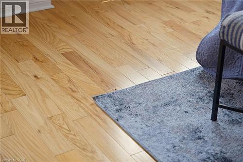 Natural wood-finish flooring with baseboard trim - 4425 Peter Drive, Burlington, ON - 