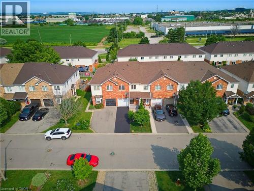 Brick and siding townhome featuring a private driveway, single-car garage, and landscaped front yard - 4425 Peter Drive, Burlington, ON - Outdoor With View