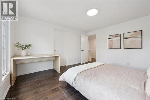 Bedroom featuring dark wood-finish flooring, white walls, and a large window - 600 White Elm Boulevard Unit# 9, Waterloo, ON - Indoor Photo Showing Bedroom