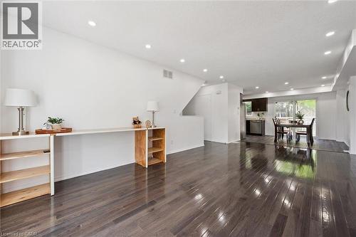 Open-concept living space featuring wood-finish flooring, recessed lighting, and a neutral color palette - 600 White Elm Boulevard Unit# 9, Waterloo, ON - Indoor