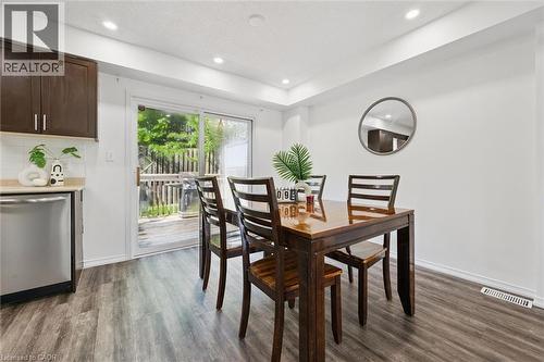 Dining area featuring wood-finish flooring, recessed lighting, and a sliding glass door to an outdoor deck - 600 White Elm Boulevard Unit# 9, Waterloo, ON - Indoor Photo Showing Dining Room