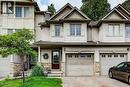 Multi-level townhouse exterior featuring vertical siding and stone veneer accents - 175 David Bergey Drive Unit# P86, Kitchener, ON  - Outdoor With Facade 