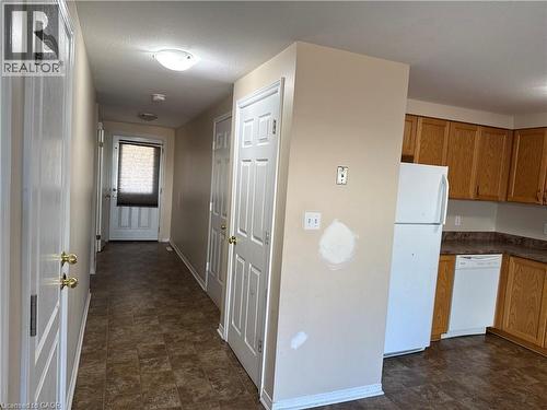 Hallway with patterned flooring, ceiling-mounted lighting, and white paneled doors - 11 Hackberry Street Unit# 1, Kitchener, ON - Indoor
