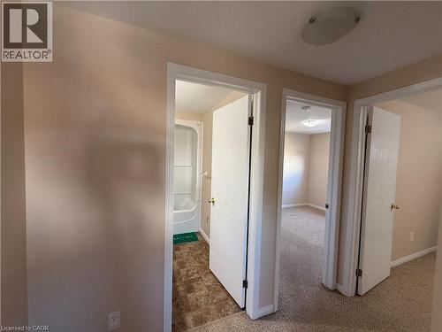 Hallway featuring neutral wall tones, white trim, and a ceiling-mounted light fixture - 11 Hackberry Street Unit# 1, Kitchener, ON - Indoor Photo Showing Other Room