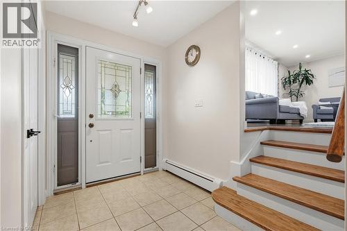 Foyer entry with a white paneled door featuring leaded glass, flanked by sidelight windows - 76 Lower Canada Crescent, Kitchener, ON - Indoor Photo Showing Other Room