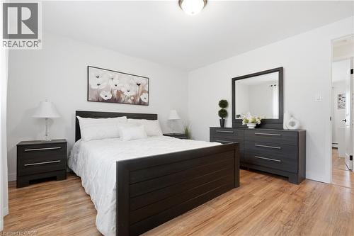 Bedroom featuring wood-finish flooring, white walls, and a ceiling-mounted light fixture - 76 Lower Canada Crescent, Kitchener, ON - Indoor Photo Showing Bedroom
