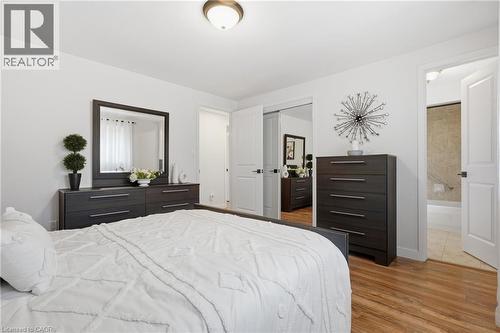 Bedroom featuring wood-finish flooring, a ceiling-mounted light fixture, and white painted walls - 76 Lower Canada Crescent, Kitchener, ON - Indoor Photo Showing Bedroom