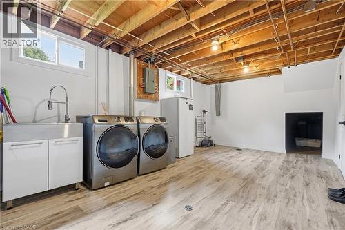Utility space featuring wood-finish flooring, exposed ceiling joists, and white walls - 76 Lower Canada Crescent, Kitchener, ON - Indoor Photo Showing Laundry Room
