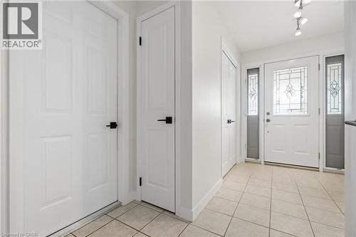 Entryway featuring a white paneled door with decorative glass, flanked by two sidelight windows with matching glass - 76 Lower Canada Crescent, Kitchener, ON - Indoor Photo Showing Other Room