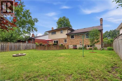 Expansive backyard featuring a manicured lawn, a built-in fire pit, and mature trees - 76 Lower Canada Crescent, Kitchener, ON - Outdoor
