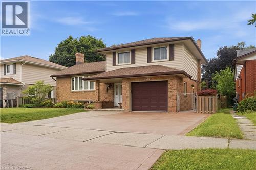 Brick and siding exterior with a two-car driveway and attached garage - 76 Lower Canada Crescent, Kitchener, ON - Outdoor